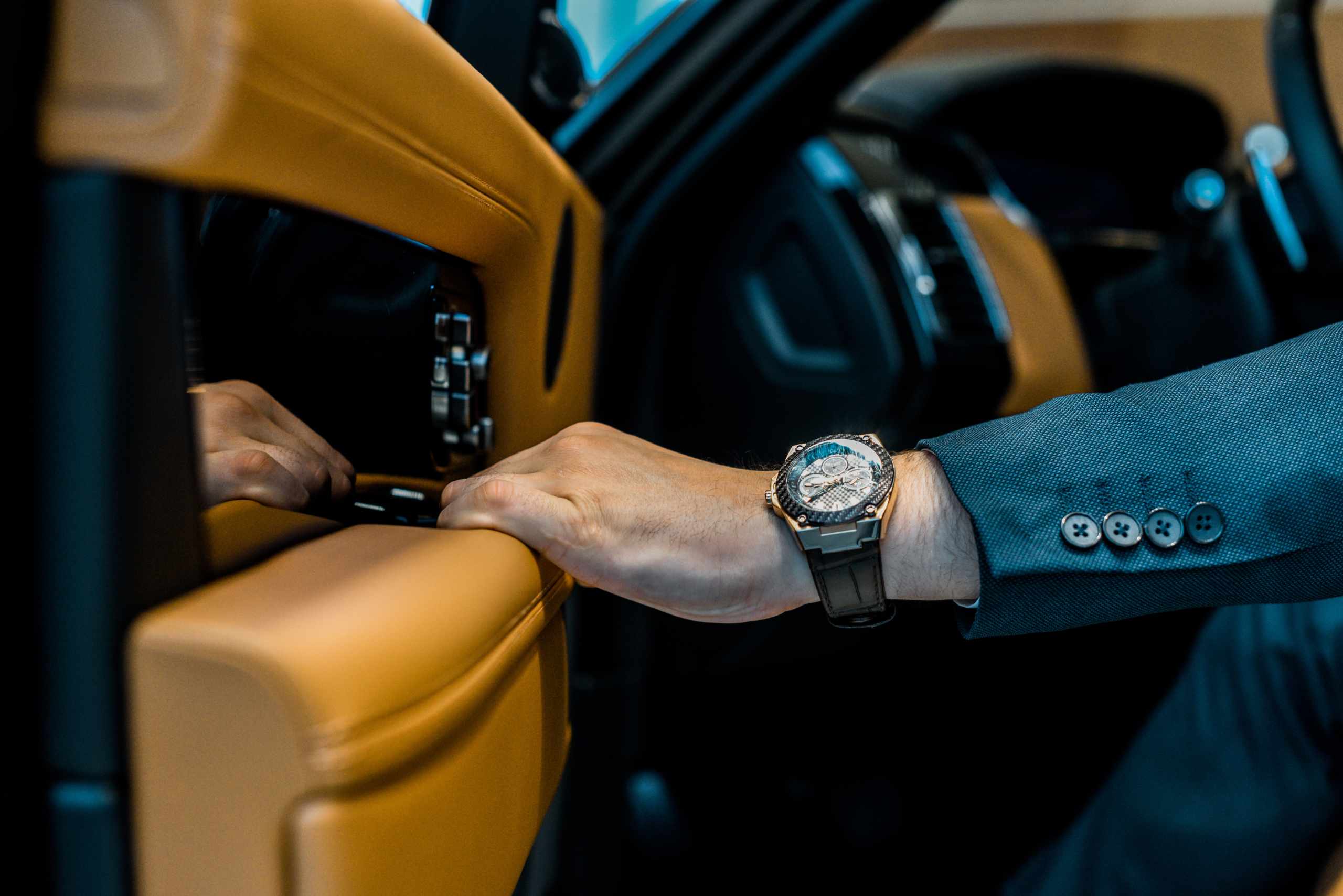 cropped image of businessman with luxury watch closing door whil